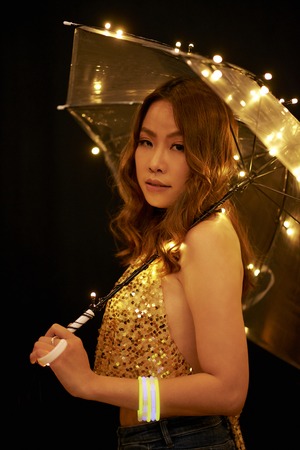 Asian woman with sparkling umbrellaの写真素材