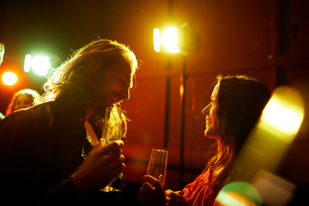 Man picking up girl at partyの写真素材