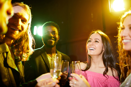Positive friends talking in nightclubの写真素材