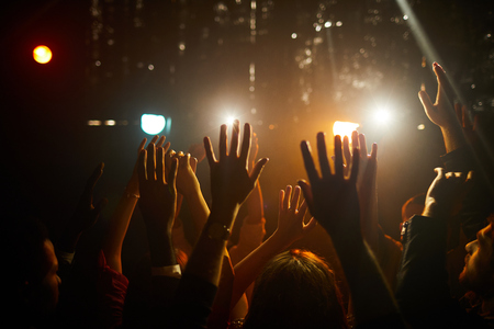 People waving hands at concertの写真素材