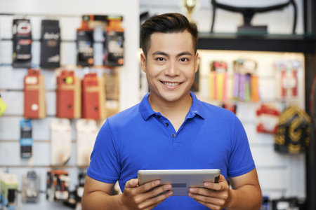 Salesman with tablet pc in the shopの写真素材