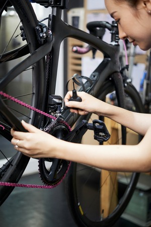 Woman preparing the bike before saleの写真素材