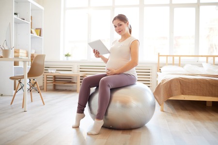 Pregnant Woman on Fitness Ballの写真素材
