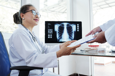 Female doctor taking medical report