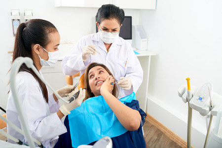Woman with toothache waiting for treatmentの写真素材
