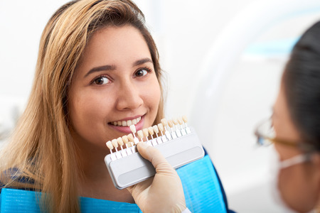 Young woman visiting doctor for teeth whiteningの写真素材