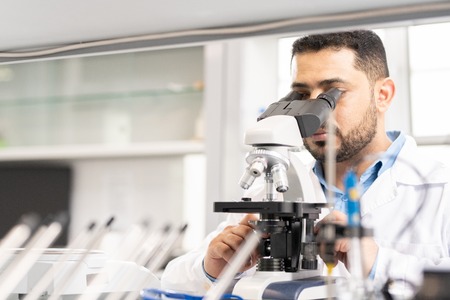 Arabian scientist using microscope
