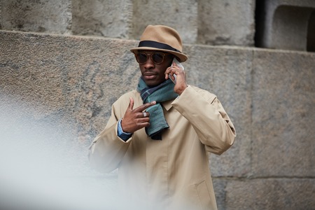 Modern African Man Speaking by Phone in Cityの写真素材