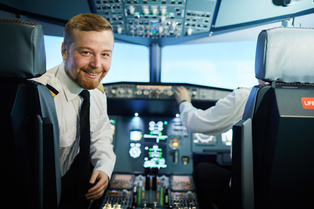 Confident bearded pilot in cockpitの写真素材