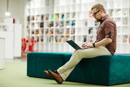 Modern guy working with laptopの写真素材