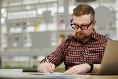 Thoughtful man preparing reportの写真素材