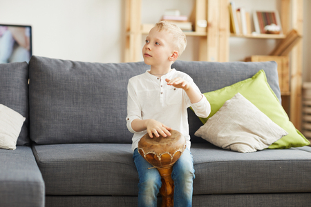 Caucasian boy playing djembeの写真素材