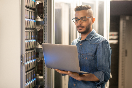 Arabian IT specialist monitoring network processesの写真素材