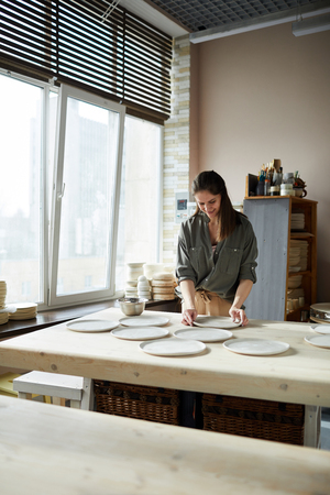 Female Ceramist Working in Studioの写真素材