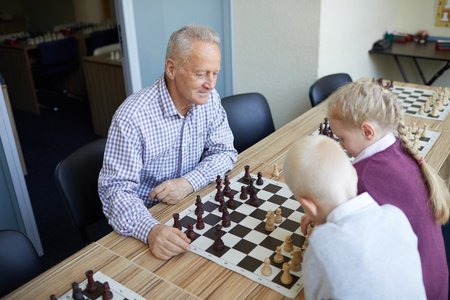 Grandfather playing against grandkidsの写真素材