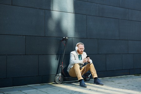 Businessman resting on city streetの写真素材