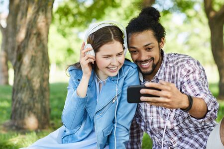 Couple Using Smartphone in Summer
