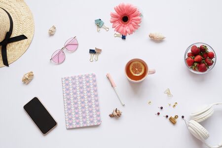 Directly above view of modern workplace of romantic designer full of vacation stuff in white and pink colorsの写真素材