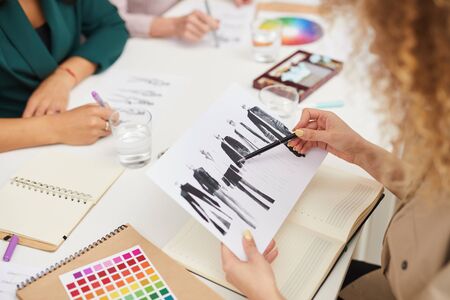 Horizontal high angle shot of unrecognizable clothes designers working on new fashionable collectionの写真素材