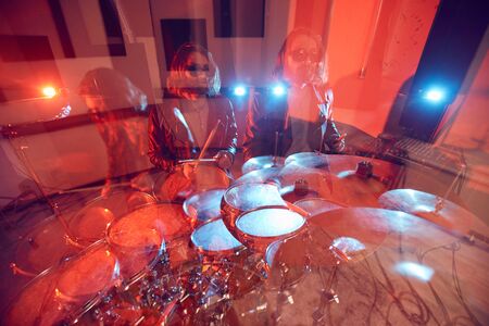 Triple image of handsome long-haired man rocking drums at music concert in stage lights, copy space