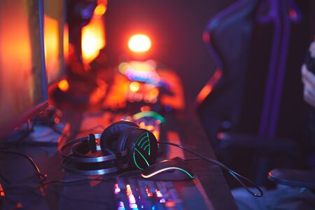 Close up of pro-gaming equipment on computer desk, focus on lit up headphones, copy spaceの写真素材
