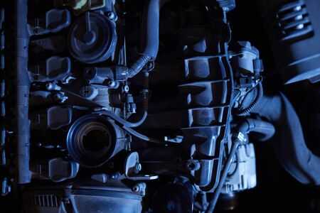 Dramatic background image of car engine in black and blue tones, auto repair shop, copy spaceの写真素材