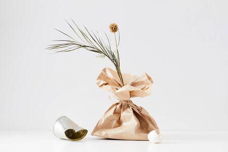 Background image of minimal composition made of trash items with floral accent, copy space