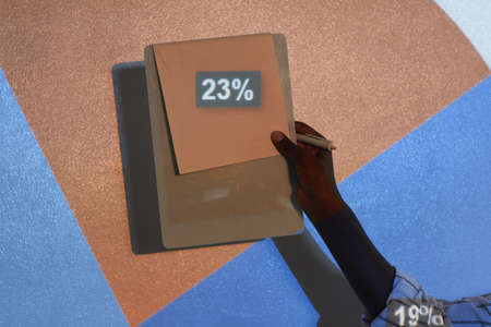 Close up of unrecognizable African-American woman giving presentation while standing by projector screen with focus on 23 percent number, copy spaceの写真素材
