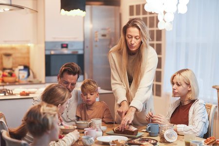 Wide angle portrait of big happy family enjoying breakfast together sitting at table in kitchen ,...