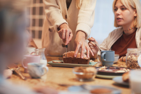 Close up of big happy family enjoying breakfast together sitting at table in kitchen , focus on...
