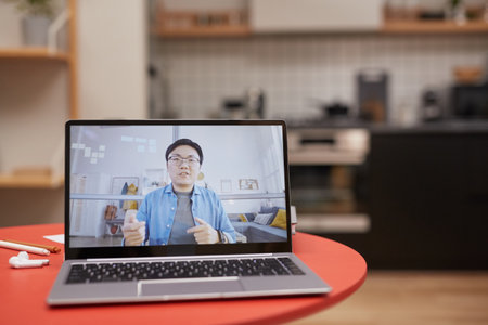 Background image of laptop with Asian man speaking on screen, online meeting or e-learning concept,...