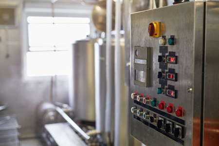 Background image of control panel with buttons and displays in workshop at production plant, copy...