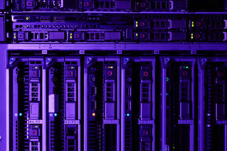 Background image of rack servers in supercomputer network lit by blue and violet light, copy space