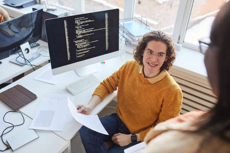 Smiling IT Programmer Working in Office