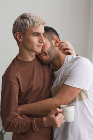 Young Gay Couple Embracing at Home