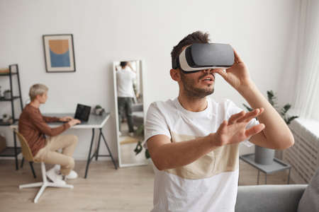 Young Man Playing VR at Homeの写真素材