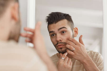 Young Man Applying Face Creamの写真素材