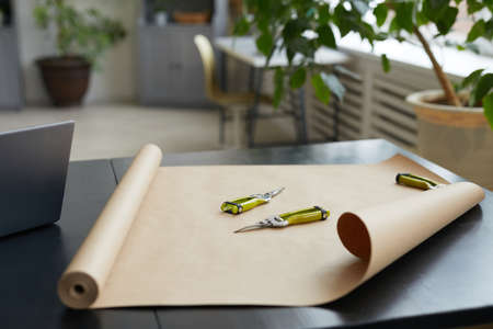 Close up of cutting tools and craft paper on table in florists workshop, copy spaceの写真素材