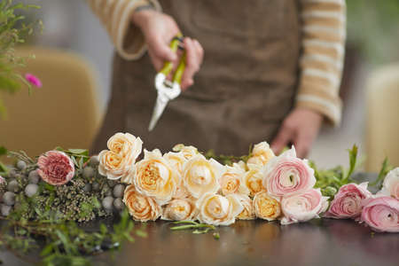 Front view close up of beautiful flowers arranged on table in florists workshop, copy spaceの写真素材