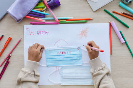 Top view close up of unrecognizable African-American child decorating mask as gift for Fathers day, copy spaceの写真素材