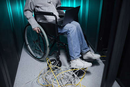 Cropped portrait of disabled woman working in server room and managing internet network, accessible job concept, copy spaceの写真素材