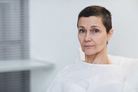 Portrait of mature woman looking at camera sitting at hospital