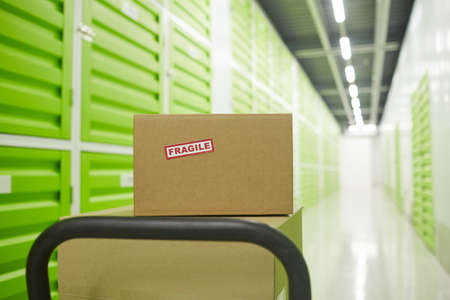 Close-up of cardboard boxes on trolley in the warehouse
