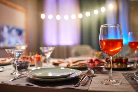 Background image of cozy home dining setting with focus on plate and wineglass, copy spaceの写真素材