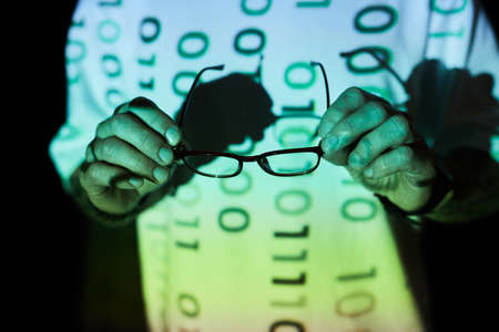 Close-up of computer programmer using eyeglasses from eyesight
