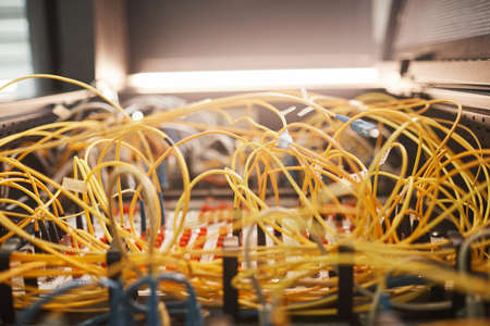 Close up of yellow wires in server room at data center background, copy space