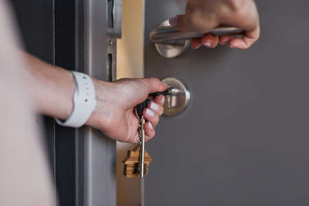 Close up of unrecognizable man opening door to new house, copy spaceの写真素材