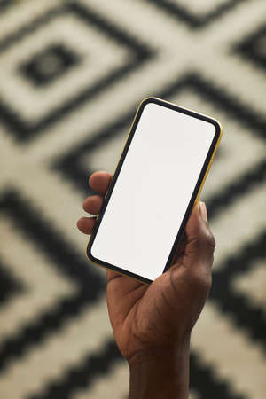 Close-up of blogger holding mobile phone with empty touch screen and working online