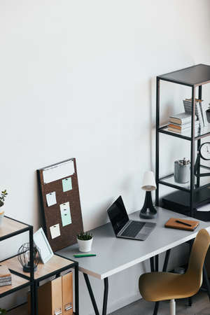 High angle view at minimal home office workplace with laptop and accessories in black and white,...