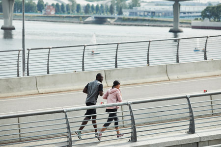 African young couple running together in the morning in the cityの写真素材